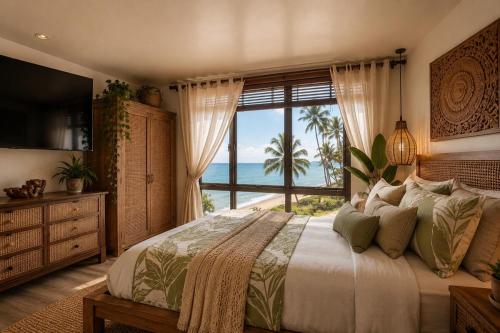 a bedroom with a bed with a view of the ocean at Wake Up to the Ocean - Beachfront Studio in Hauula