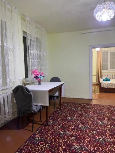 a dining room with a table and chairs on a rug at Dream house in Türgen