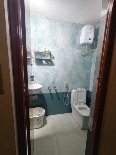 a small bathroom with a toilet and a sink at Vriksha Heritage Farm Stays in Sethumadai