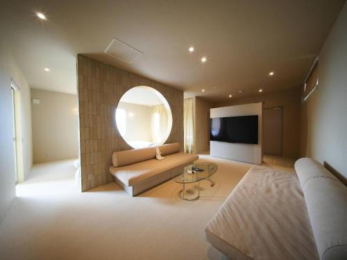 a living room with a couch and a large mirror at Over the MOON in Awaji