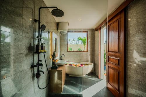 a bathroom with two sinks and a bath tub at The Solas Villa Ubud in Ubud