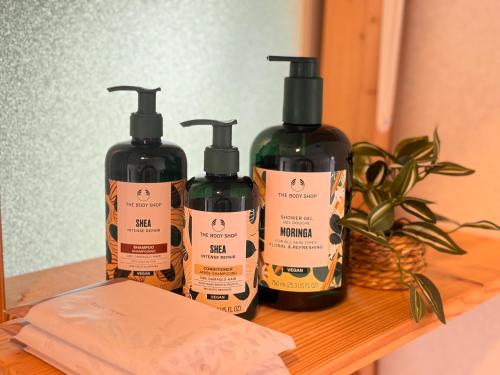 three bottles of hair products sitting on a shelf at HAMARs ITOMAN HOUSE - ReFaｼｬﾜｰﾍｯﾄﾞ&ﾄﾞﾗｲﾔｰ完備 - 南部観光の拠点 - 1日1組限定 in Itoman