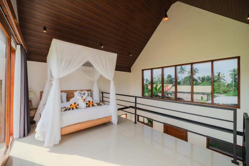 a bedroom with a bed with a canopy at The Solas Villa Ubud in Ubud