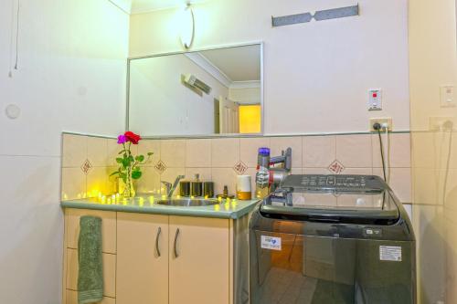 a small kitchen with a sink and a stove at Serenity Rainforest Retreat With Breathtaking Gold Coast Views - Sleeps 4 - 6 people in Springbrook
