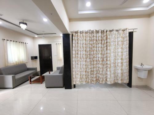 a living room with a couch and a shower curtain at Hotel Seven Dreamers in Vākalapūdi