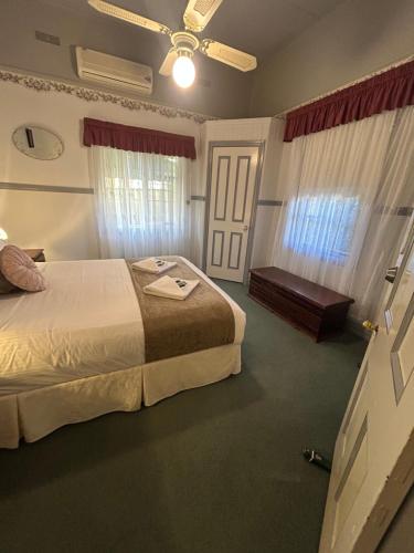 a hotel room with a bed and a window at Foundry Cottages in Rutherglen