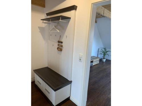 a room with a white closet with a shelf at grosser-Fiete in Wittdün