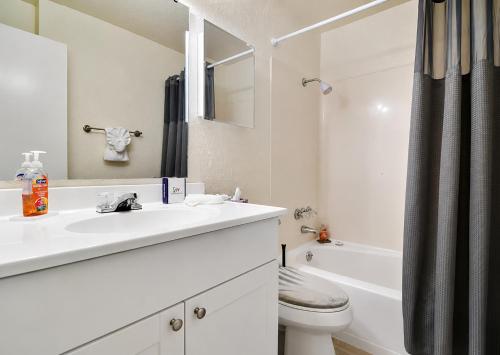 a white bathroom with a sink and a toilet at Cozy Lakefront Home in Lake Wales
