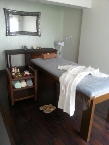 a room with a bed with a mirror and a shelf at The Meadows Resort and Spa in Aurangabad