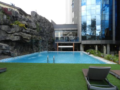 a swimming pool in the middle of a building at PrideInn Azure Hotel Nairobi Westlands in Nairobi