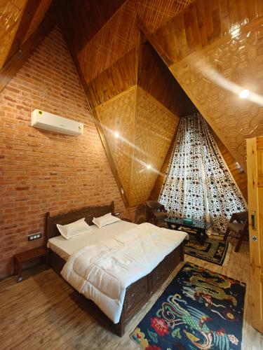 a bedroom with a large bed in a attic at French Woods Cottages in Srinagar