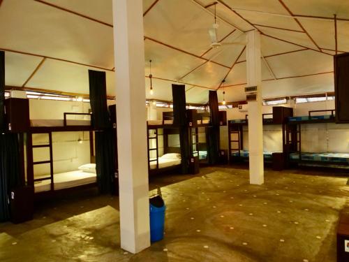 a room with several bunk beds in it at Way of The Bay in Arugam Bay