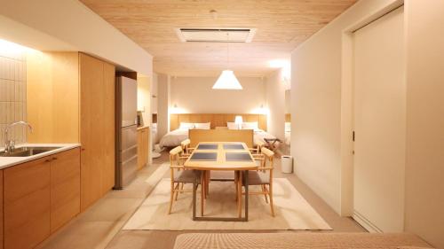 a kitchen and dining room with a table in a room at ジローズガーデン in Ishinomaki