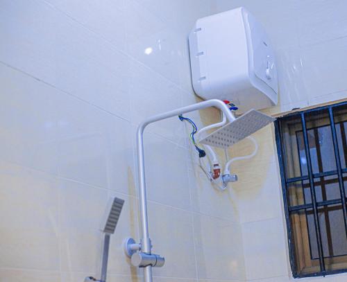 a water heater on the wall of a bathroom at CAM Apartments in Dodoma