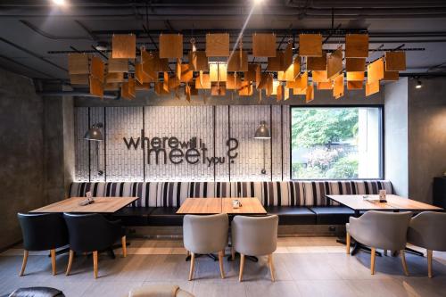 a restaurant with two tables and chairs and a chandelier at Shama Lakeview Asoke Bangkok in Bangkok
