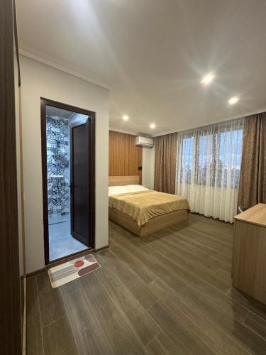 a hotel room with a bed and a mirror at Luso in Batumi