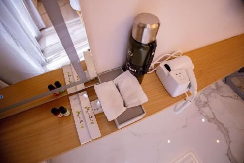 a coffee machine sitting on a counter in a room at Hotel Vibrama in Tirupati