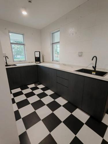 a kitchen with a black and white checkered floor at D'Monochrome in Singapore
