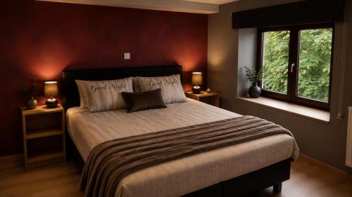 a bedroom with a large bed and a window at Maison Samree met Indoor Wellness in La-Roche-en-Ardenne