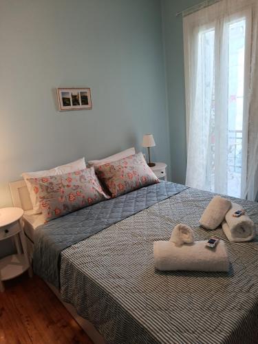 a bedroom with a bed with towels on it at Lefkada Old Town Kantouni in Lefkada