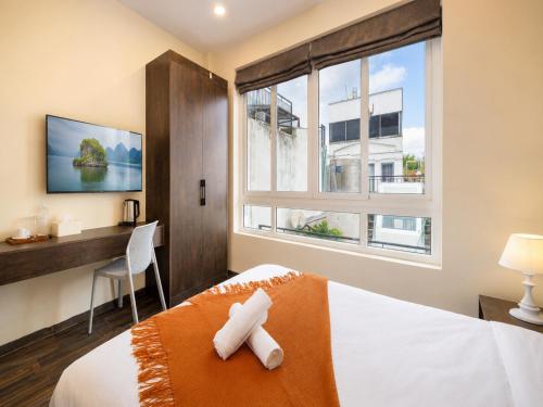 a bedroom with a bed and a desk and a window at Diamond crown 2 Hotel in Ho Chi Minh City