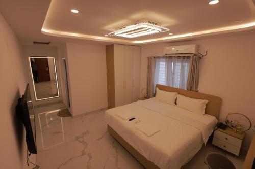 a bedroom with a bed and a television in it at Hotel Vibrama in Tirupati