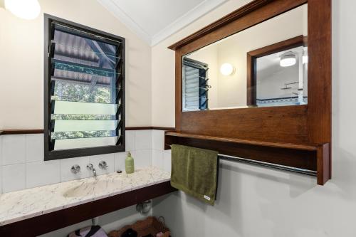 a bathroom with a sink and a mirror at The Courthouse Bed & Breakfast in Broome