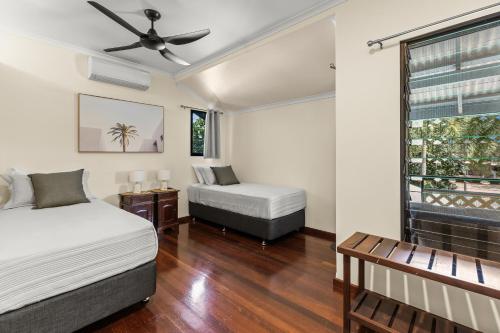 a bedroom with two beds and a window at The Courthouse Bed & Breakfast in Broome