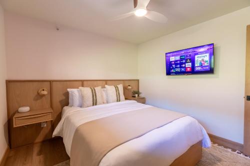 a bedroom with a bed and a tv on the wall at Switchback at Edelweiss in Whitefish