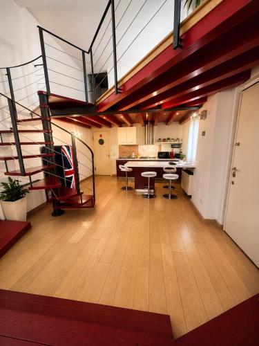 a living room with a staircase and a table and chairs at al home in Crema
