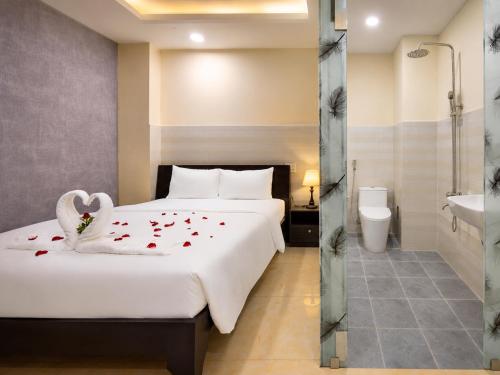 a hotel room with a bed with hearts on it at Diamond crown 2 Hotel in Ho Chi Minh City