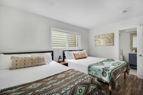 a bedroom with two beds and a window at Beachfront Condo on A LowKey Beach in Sunset Beach
