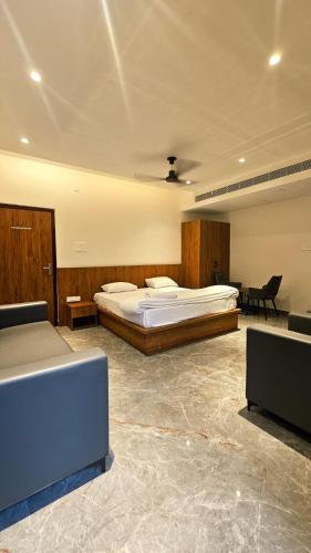 a bedroom with a large bed and a desk at Kosala grand in Bhadrāchalam