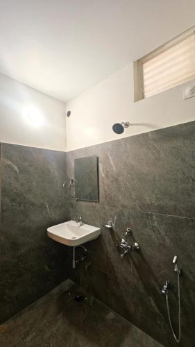 a bathroom with a sink and a shower at Kosala grand in Bhadrāchalam