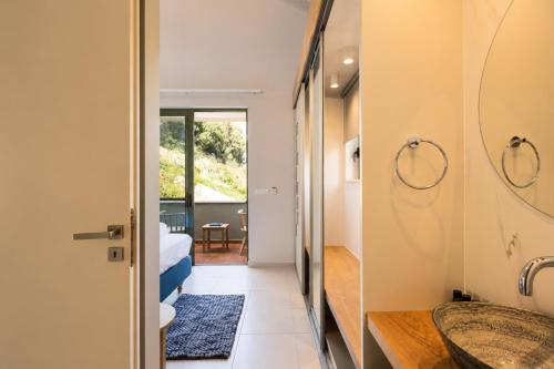 a bathroom with a sink and a mirror at Physis Villas Chania in Ayiá