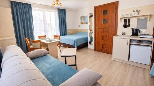a living room with a couch and a kitchen at Harpun in Władysławowo