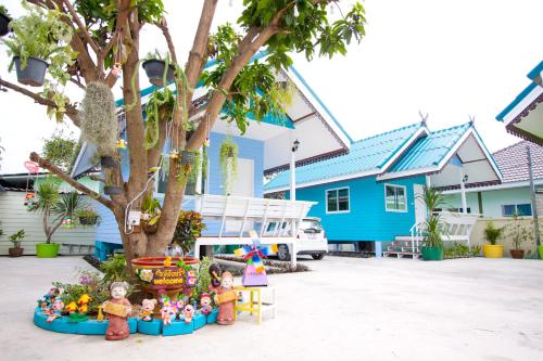 a group of toy figurines in front of a blue house at Bannrommai Sattahip in Sattahip
