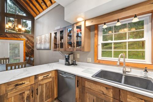a kitchen with wooden cabinets and a sink at Stones Throw in Hill City