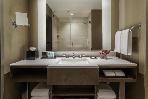 a bathroom with a sink and a large mirror at Hyatt Regency Tysons Corner Center in Tysons Corner