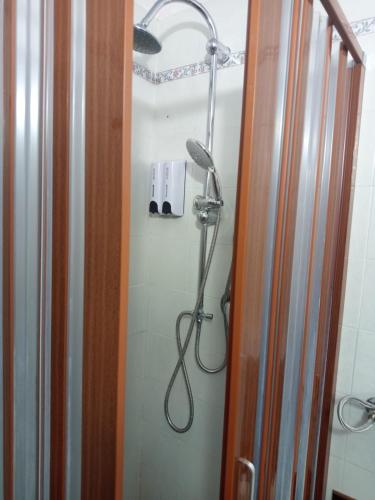a bathroom with a shower with a shower head at Curtigghiu Room in Avola