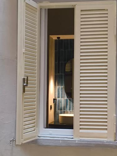 a window of a bathroom with a sink at Philosofia in Naples
