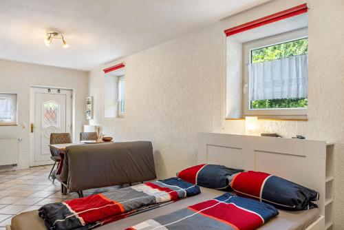 a room with a bed and a table and a window at Belroki Ranch in Waldeck