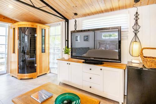 a living room with a flat screen tv on a counter at Chiara's Wellness Studio Sauna and Outdoor Bath in Sorrento