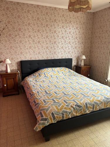 a bed in a bedroom with two night stands and two lamps at Longère du Perche in Montigny-le-Chartif