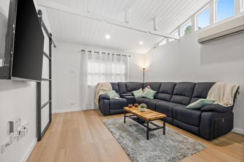 a living room with a couch and a table at What-A-View Cottage Halls Gap in Halls Gap