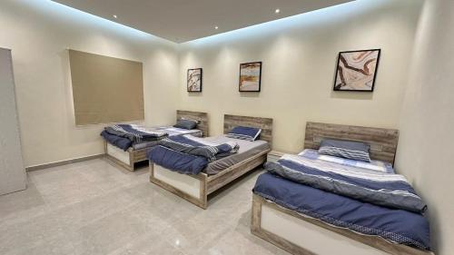 a group of four beds in a room at Al Hawli pool gathering in Salalah