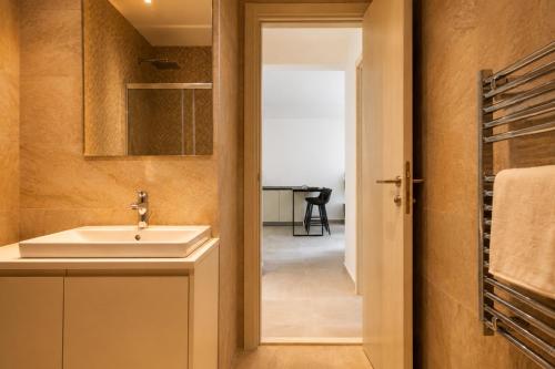 a bathroom with a sink and a mirror at Vinyl & Wine Retreat by THE HOUSE Experience Collection in Škaljari