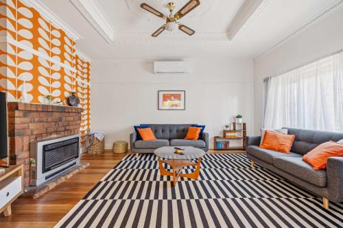 a living room with two couches and a tv at Brighton Belle Stawell in Stawell