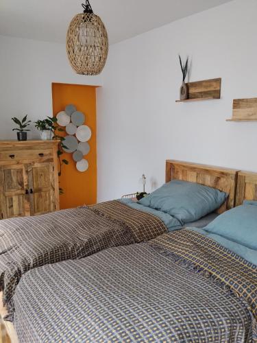 two beds sitting next to each other in a bedroom at Apartmán pod hradom B in Trenčín