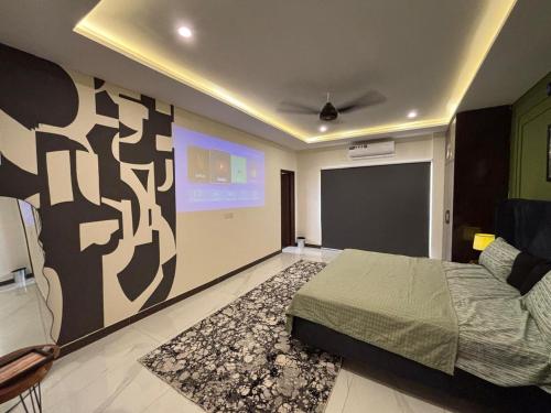 a bedroom with a bed and a projection screen at Spacious Apartment by Urban Residence in Multan